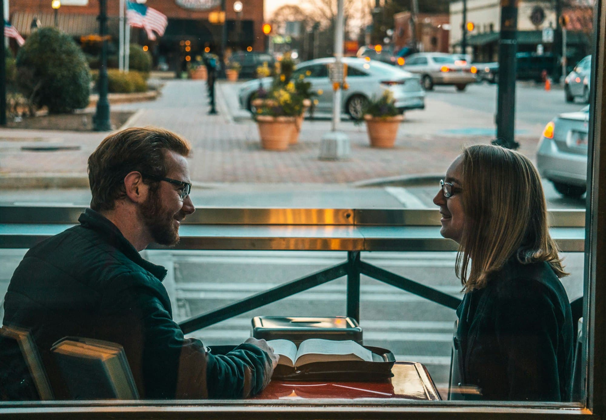 A couple in a warm, connected conversation at a café
